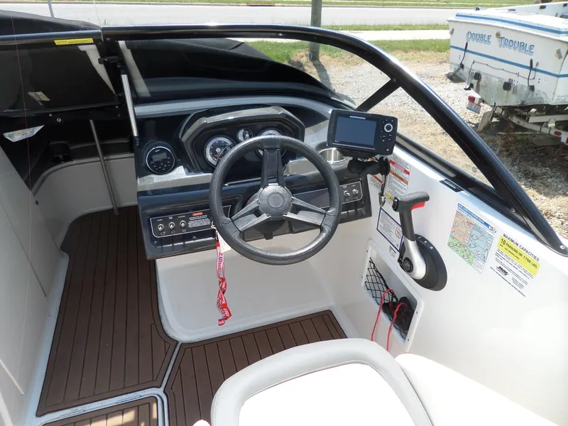 Slide: The Image of 2017 Bayliner VR6 Bowrider I/O cockpit with steering wheel and control panel. - 13