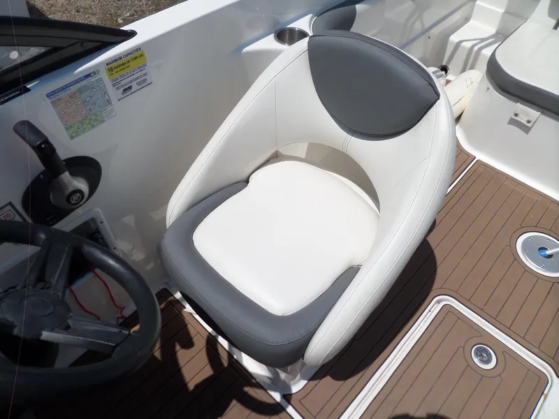 Slide: The Image of 2017 Bayliner VR6 Bowrider I/O boat interior with steering wheel and cushioned seat. - 20