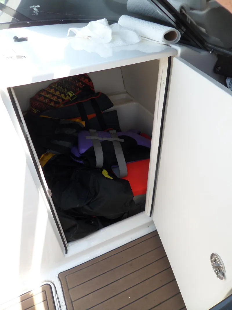 Slide: The Image of Storage compartment on 2017 Bayliner VR6 Bowrider I/O with life jackets and gear. - 36