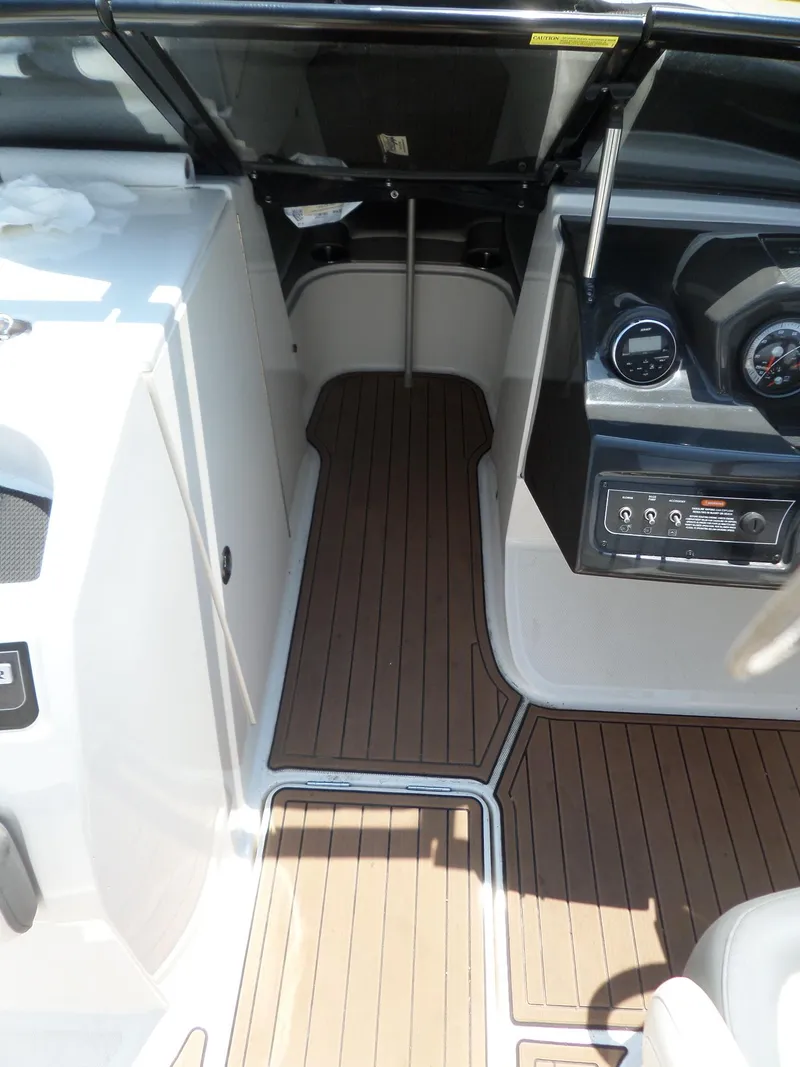Slide: The Image of 2017 Bayliner VR6 Bowrider I/O interior with wood-style flooring and dashboard controls. - 37