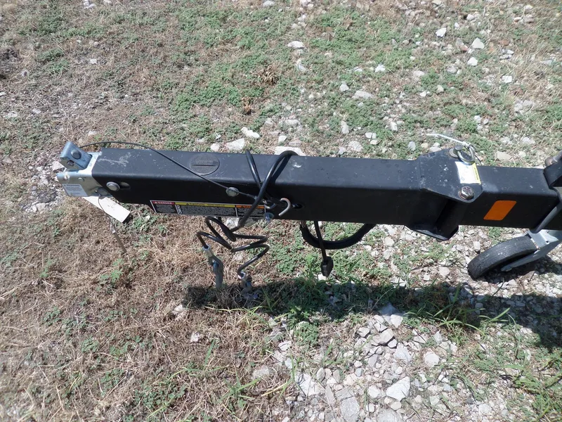 Slide: The Image of Trailer hitch of a 2017 Bayliner VR6 Bowrider I/O on rocky ground. - 7