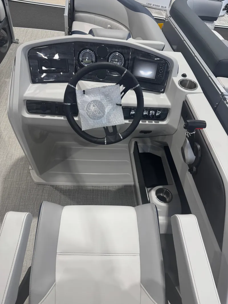 Slide: The Image of 2025 Avalon 2385 25 LSZ VRL boat dashboard with steering wheel and controls. - 6