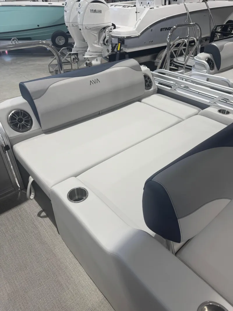 Slide: The Image of 2025 Avalon 2385 25 LSZ VRL boat interior with cushioned seating and cup holders. - 9