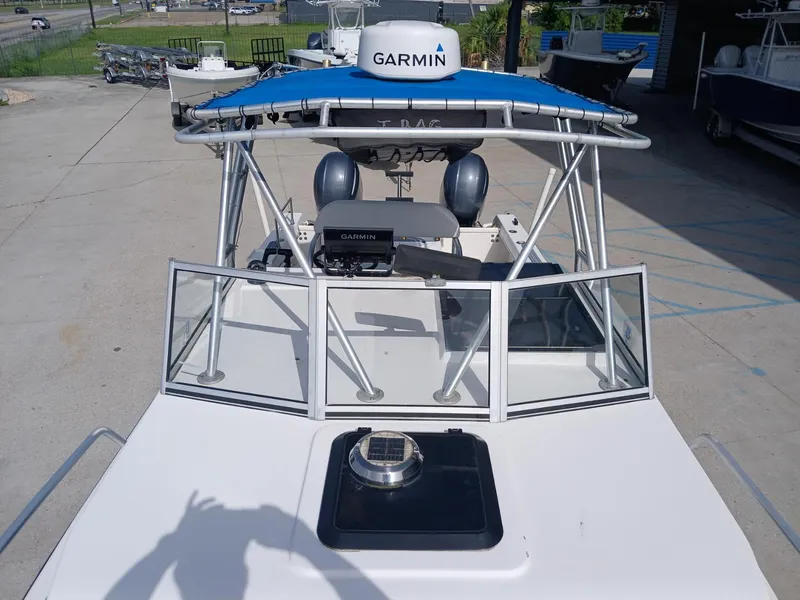 Slide: The Image of 2005 Twin Vee 26 Weekender boat with Garmin equipment, docked outdoors. - 10