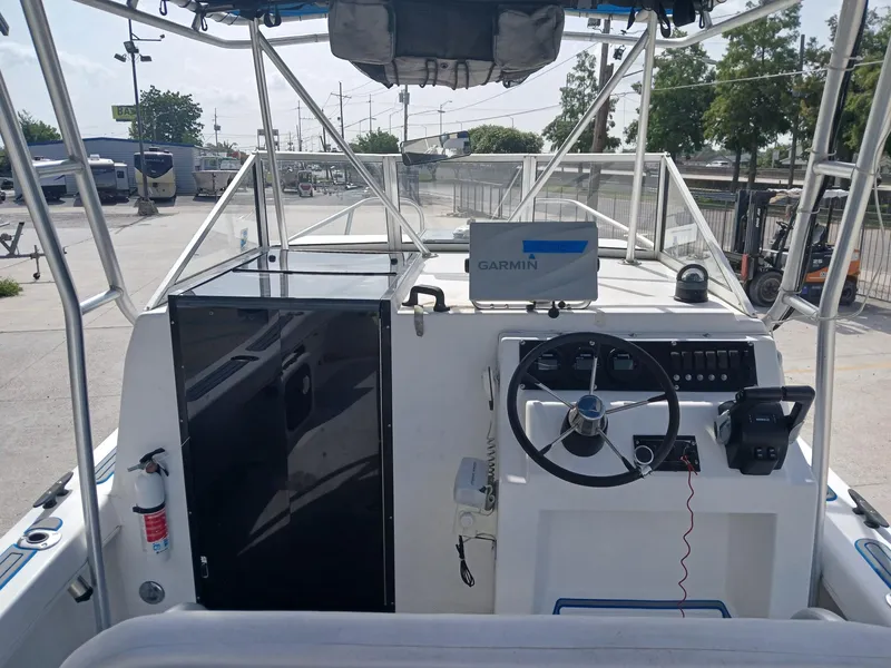 Slide: The Image of 2005 Twin Vee 26 Weekender boat cockpit with Garmin navigation system and steering wheel. - 11
