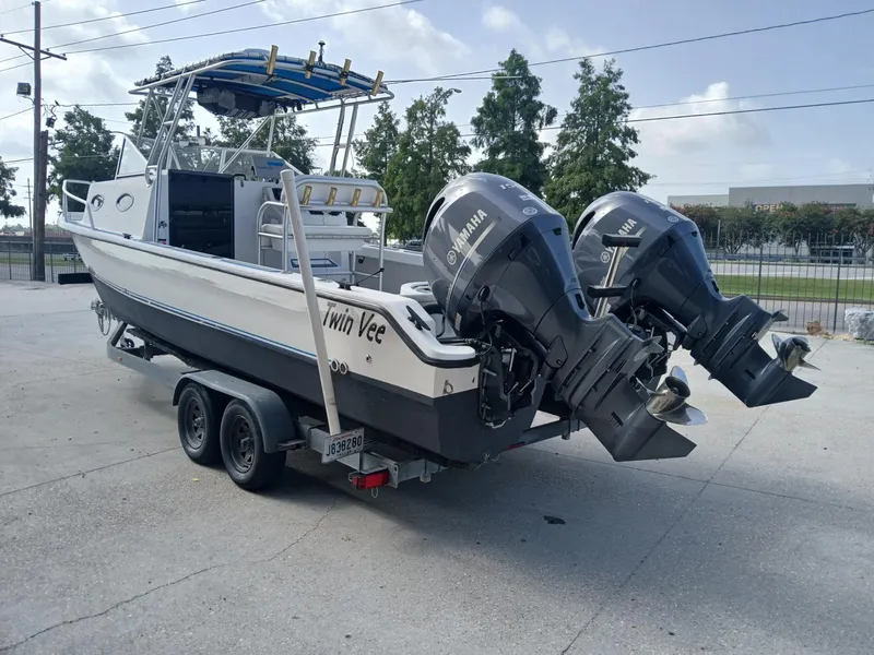 Slide: The Image of 2005 Twin Vee 26 Weekender boat on trailer with dual Yamaha outboard motors. - 14