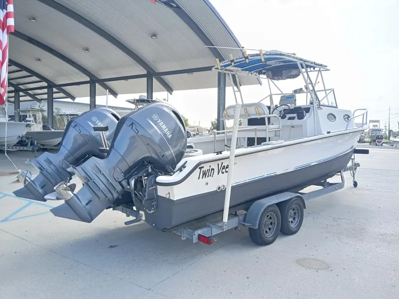 Slide: The Image of 2005 Twin Vee 26 Weekender boat with dual Yamaha engines on a trailer. - 15