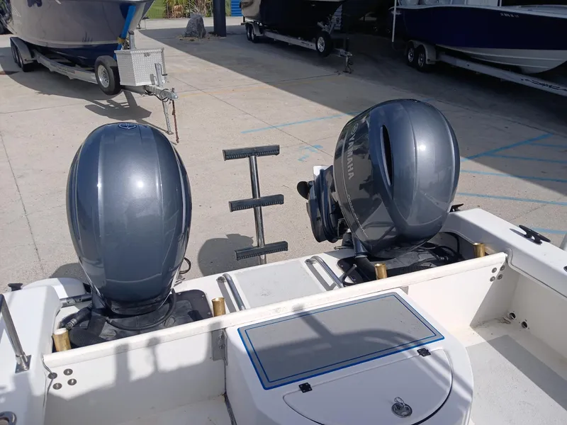 Slide: The Image of Twin Vee 26 Weekender 2005 boat with dual outboard motors in a marina. - 2