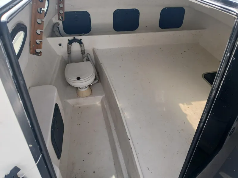 Slide: The Image of 2005 Twin Vee 26 Weekender boat interior with toilet and storage compartments. - 6