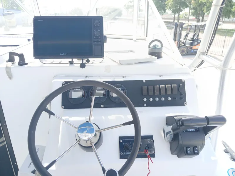 Slide: The Image of 2005 Twin Vee 26 Weekender boat dashboard with Garmin display and Yamaha controls. - 7