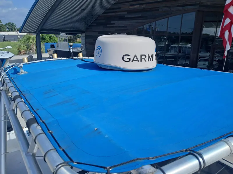 Slide: The Image of 2005 Twin Vee 26 Weekender boat with Garmin radar on blue canopy. - 8