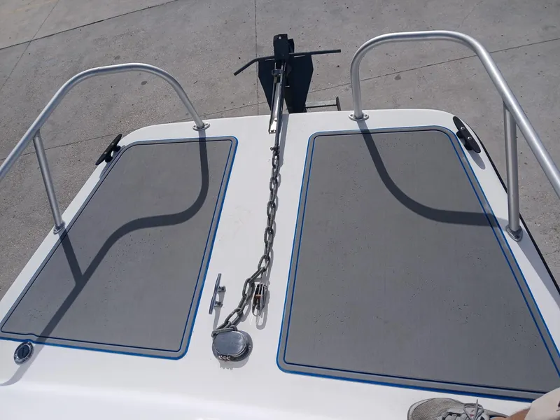Slide: The Image of 2005 Twin Vee 26 Weekender boat deck with anchor chain and railings. - 9