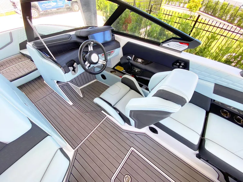 Slide: The Image of 2024 Nautique Super Air Nautique G21 interior with modern helm and seating. - 11