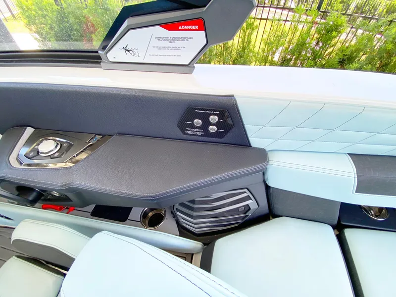 Slide: The Image of 2024 Nautique Super Air Nautique G21 interior with control panel and seating. - 12