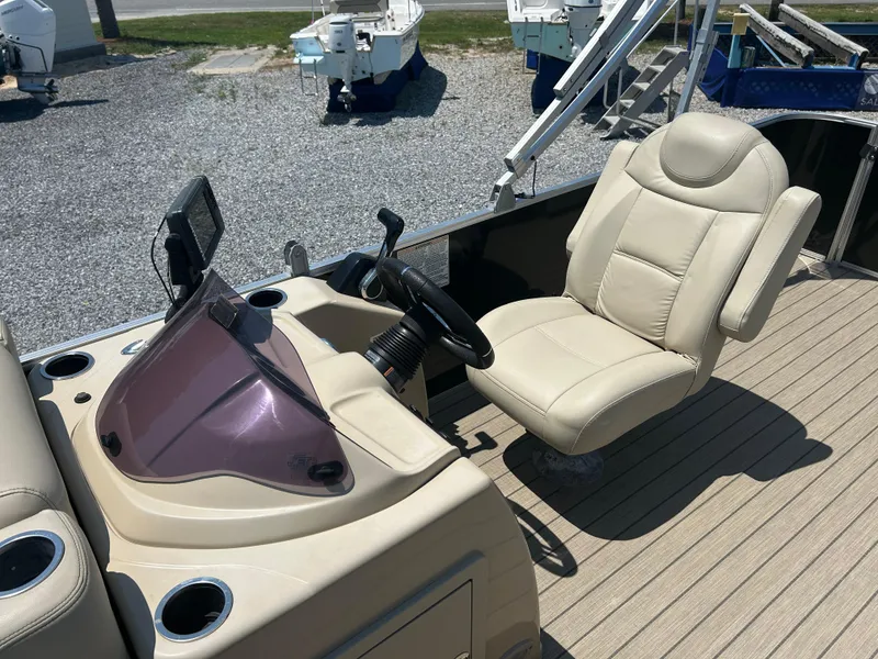 Slide: The Image of 2018 Sylvan Mirage 8522 Cruise boat interior with steering console and captain's chair. - 12