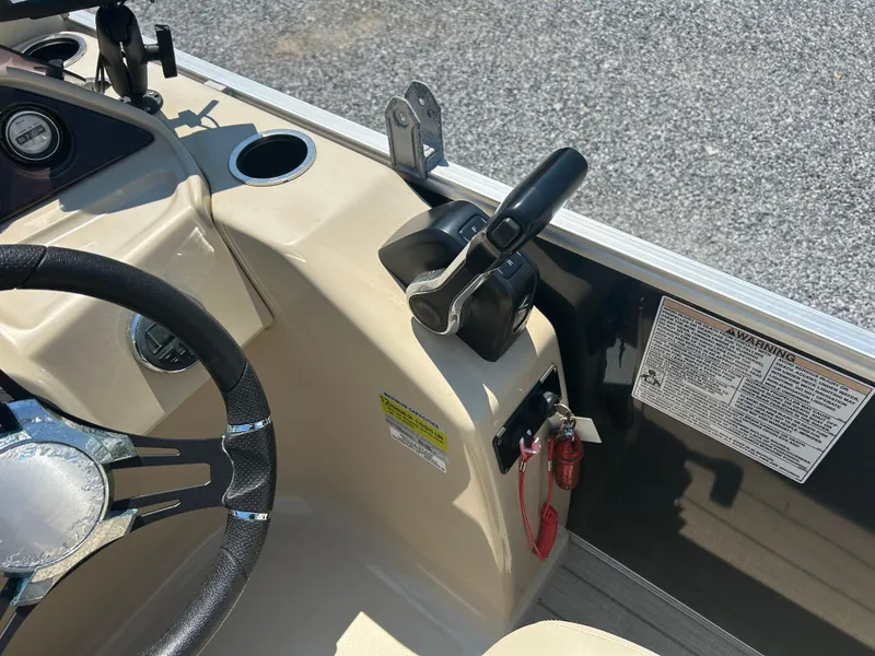 Slide: The Image of 2018 Sylvan Mirage 8522 Cruise boat dashboard with steering wheel and throttle controls. - 16