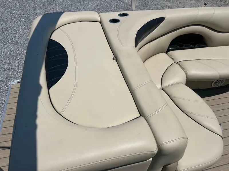 Slide: The Image of 2018 Sylvan Mirage 8522 Cruise boat interior with beige seating and cup holders. - 18