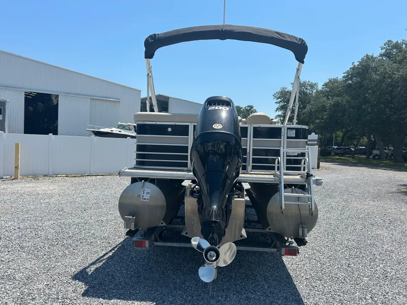 Slide: The Image of 2018 Sylvan Mirage 8522 Cruise pontoon boat with outboard motor, parked on gravel. - 4
