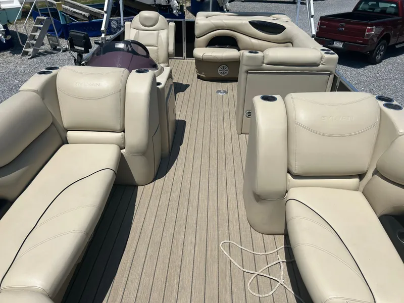 Slide: The Image of 2018 Sylvan Mirage 8522 Cruise pontoon boat with beige seating and spacious deck layout. - 8