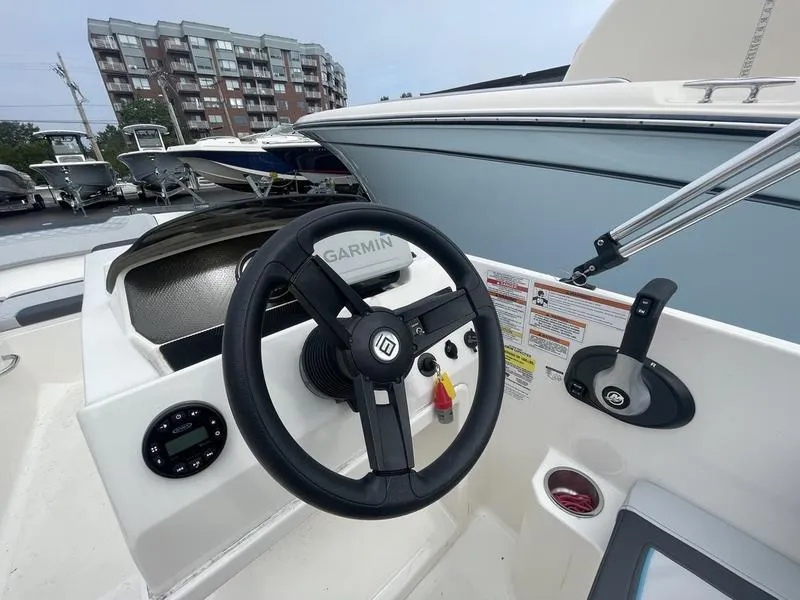 Slide: The Image of 2022 Bayliner 170 Element boat dashboard with Garmin steering wheel and controls. - 3