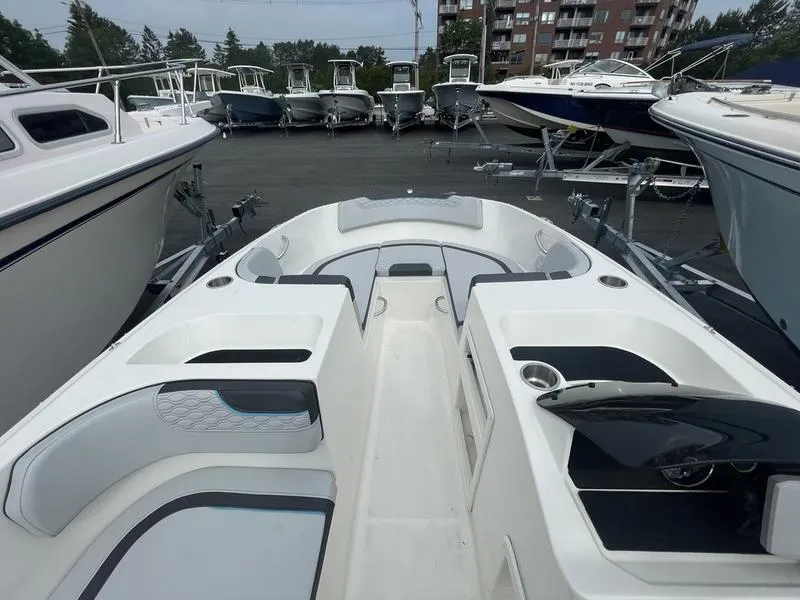 Slide: The Image of 2022 Bayliner 170 Element boat interior with seating and storage, displayed among other boats. - 5