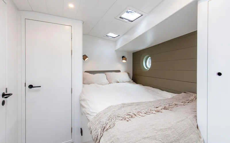 Slide: The Image of Cozy cabin interior of Bestevaer 53 S/Y 2026 with a comfortable bed and modern lighting. - 17