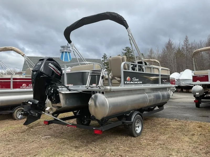 Slide: The Image of 2025 Sun Tracker PARTY BARGE® 18 DLX pontoon boat on trailer, outdoor display. - 8
