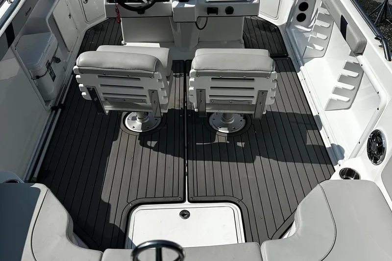 Slide: The Image of 2024 Godfrey 231 Center Console boat interior with gray seating and flooring. - 10