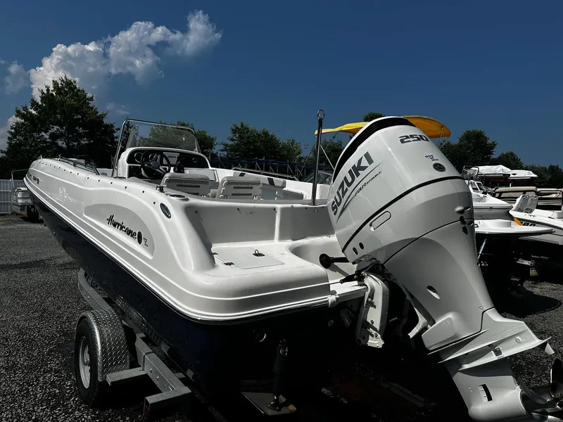 Slide: The Image of 2024 Godfrey 231 Center Console boat with Suzuki engine on trailer. - 2