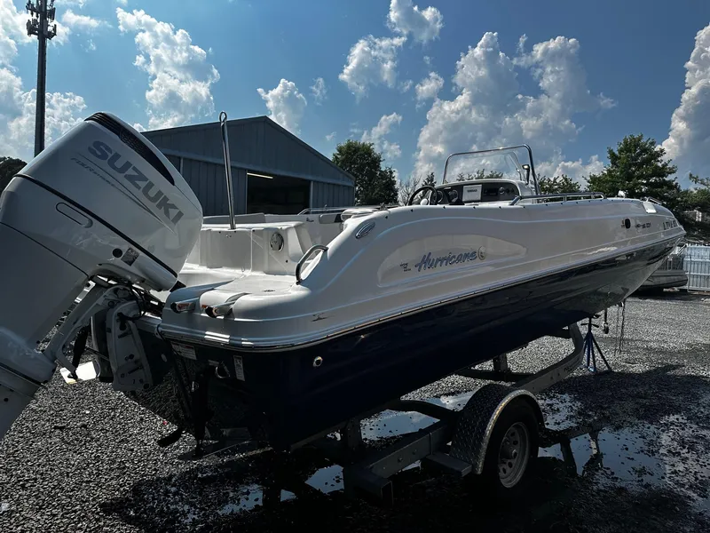 Slide: The Image of 2024 Godfrey 231 Center Console boat with Suzuki engine on trailer, outdoors. - 3