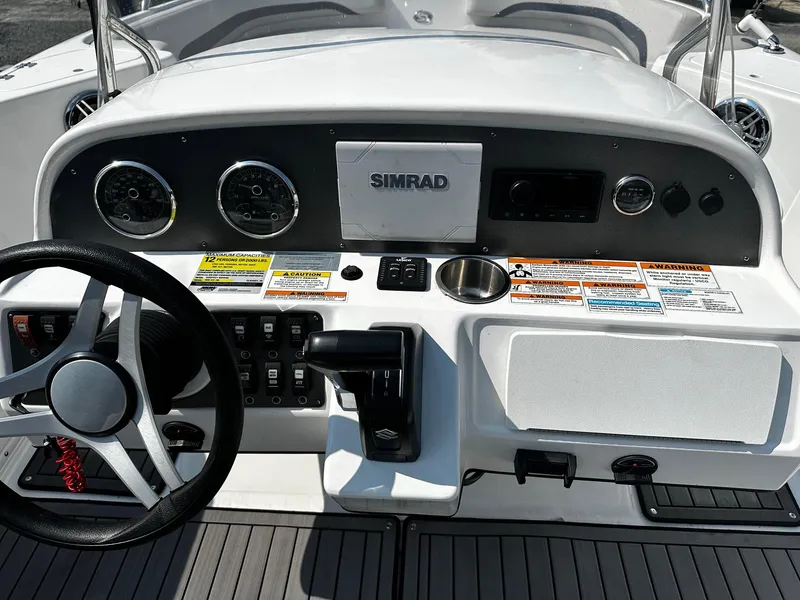Slide: The Image of 2024 Godfrey 231 Center Console dashboard with steering wheel and control panel. - 4