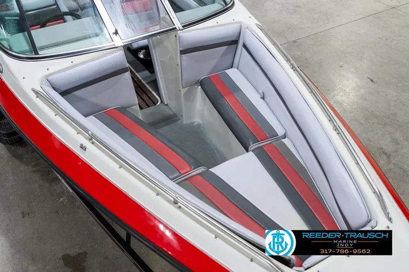 Slide: The Image of Interior of 1991 Caravelle I2300CC boat with red and gray seating. - 11