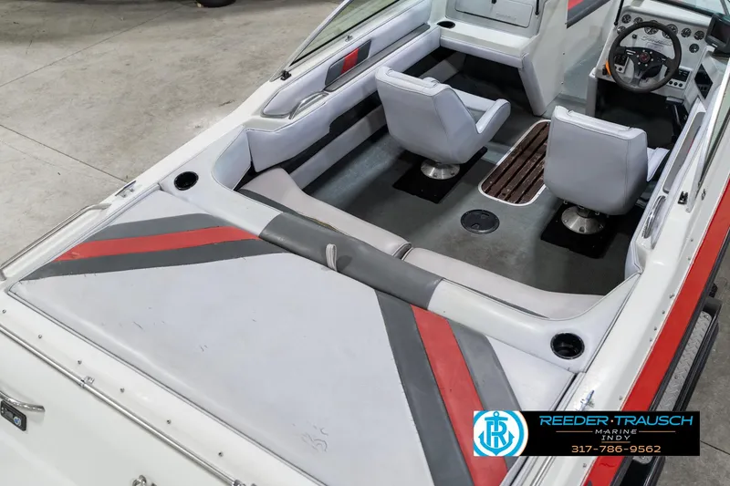 Slide: The Image of Interior of a 1991 Caravelle I2300CC boat with gray and red seating. - 12