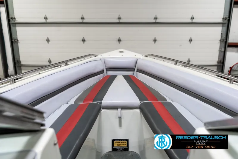 Slide: The Image of Interior of 1991 Caravelle I2300CC boat with red and gray seating. - 16