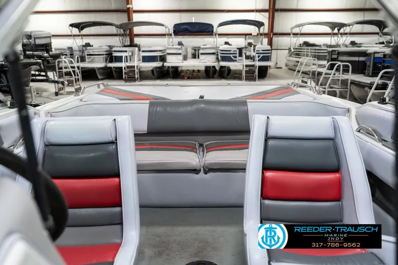 Slide: The Image of Interior of a 1991 Caravelle I2300CC boat with red and gray seating. - 18