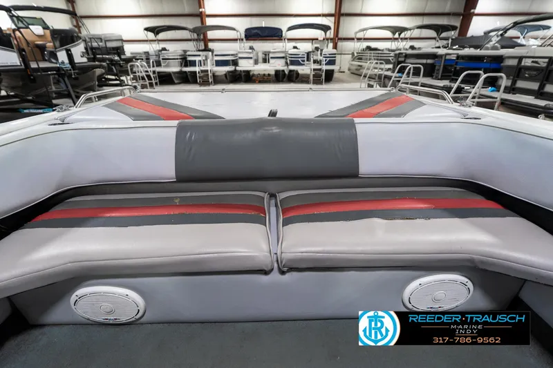 Slide: The Image of Interior of a 1991 Caravelle I2300CC boat with gray and red seating. - 19