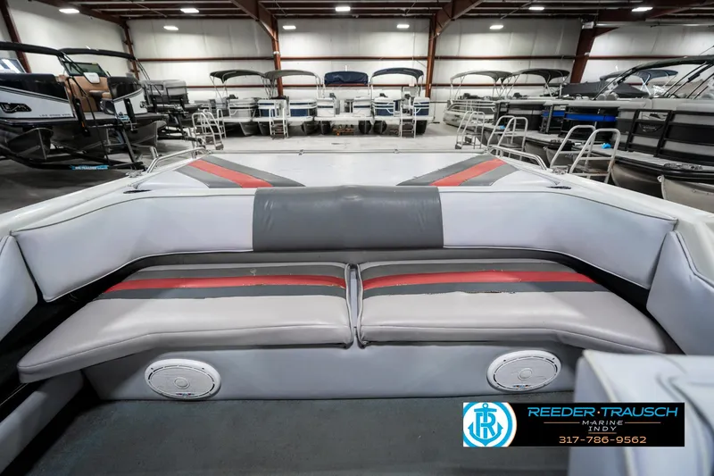 Slide: The Image of Interior of a 1991 Caravelle I2300CC boat with gray and red seating. - 22