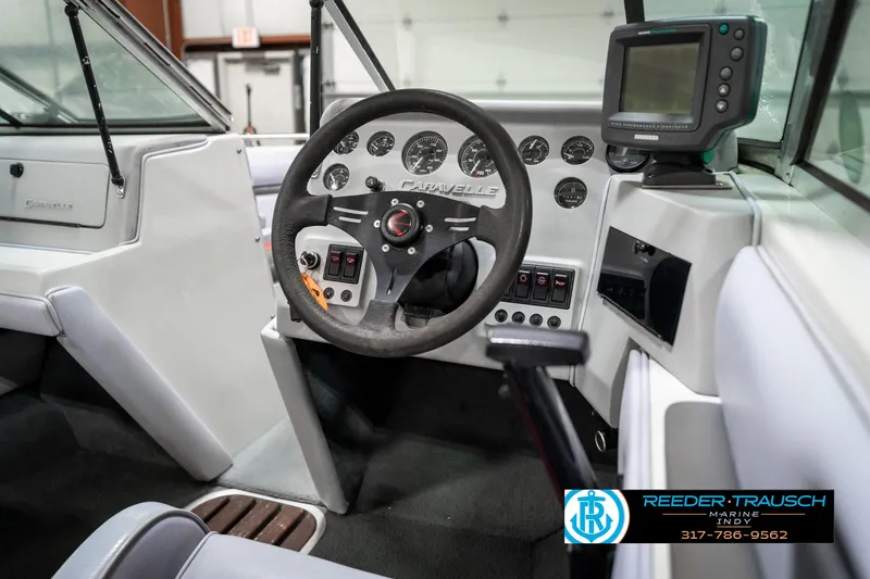 Slide: The Image of Interior of a 1991 Caravelle I2300CC boat, featuring steering wheel and dashboard controls. - 25