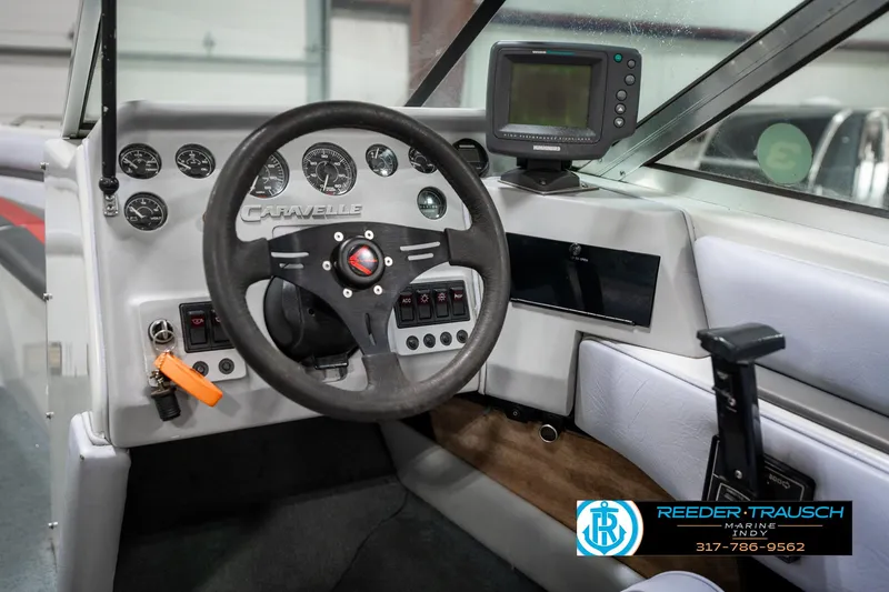 Slide: The Image of Interior of a 1991 Caravelle I2300CC boat with steering wheel and dashboard controls. - 26