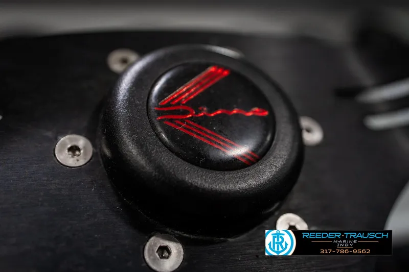 Slide: The Image of Close-up of a 1991 Caravelle I2300CC boat detail with red emblem. - 27