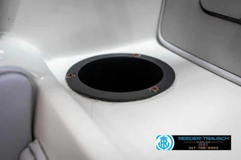 Slide: The Image of 1991 Caravelle I2300CC boat cup holder detail with Reeder-Trausch Marine logo. - 34
