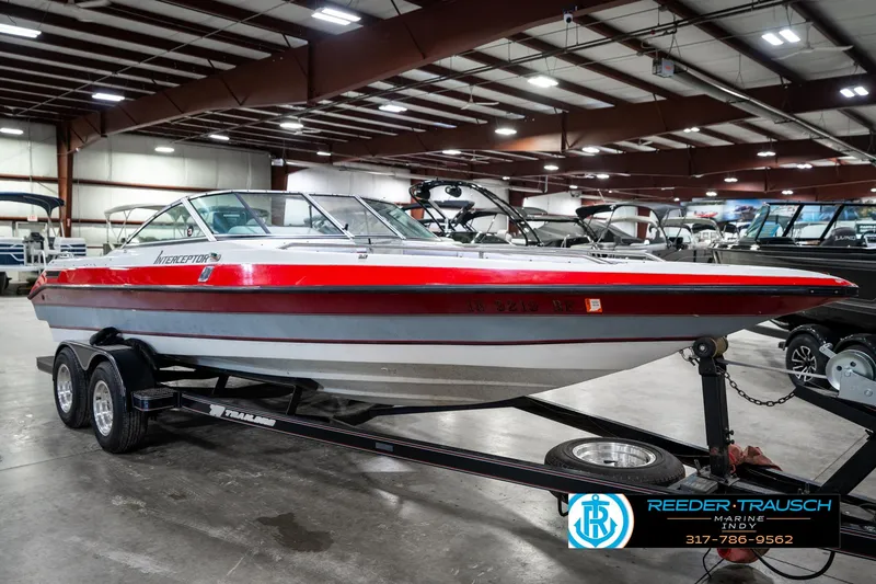 Slide: The Image of 1991 Caravelle I2300CC boat on trailer in indoor showroom. - 4