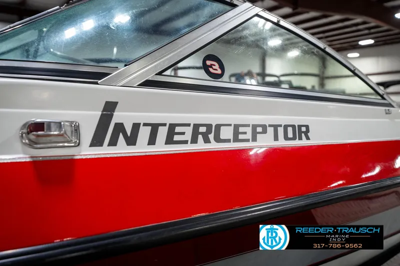Slide: The Image of 1991 Caravelle I2300CC boat with "Interceptor" branding, red and white design, indoor setting. - 41