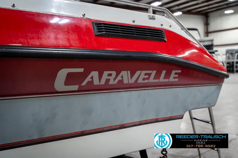 Slide: The Image of Red and white 1991 Caravelle I2300CC boat in indoor storage facility. - 42