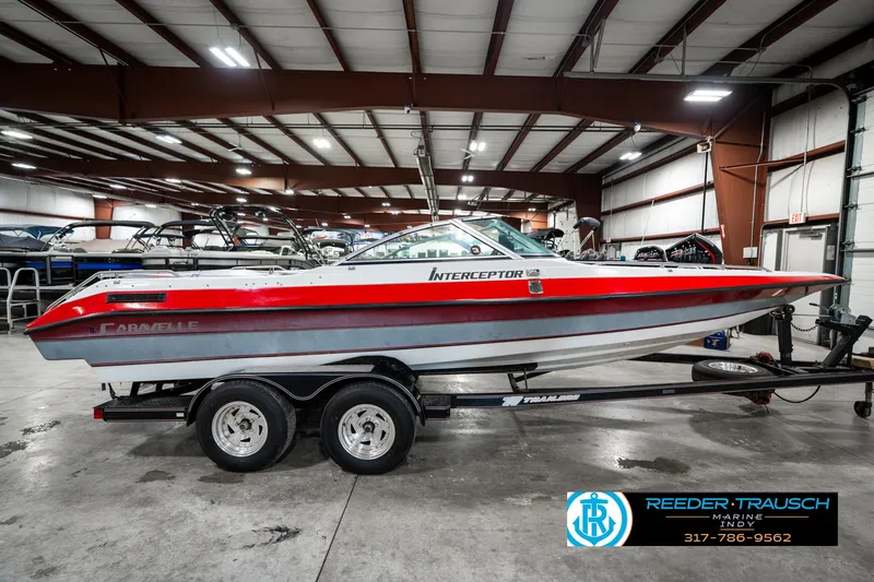 Slide: The Image of 1991 Caravelle I2300CC boat on trailer in indoor showroom. - 5