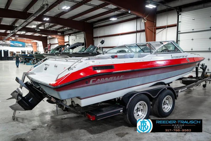 Slide: The Image of 1991 Caravelle I2300CC boat on trailer in indoor showroom. - 6