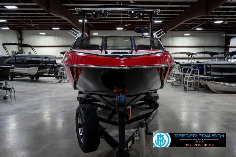 Slide: The Image of 2017 Malibu Wakesetter 25 LSV boat in showroom, front view, red and black design. - 10