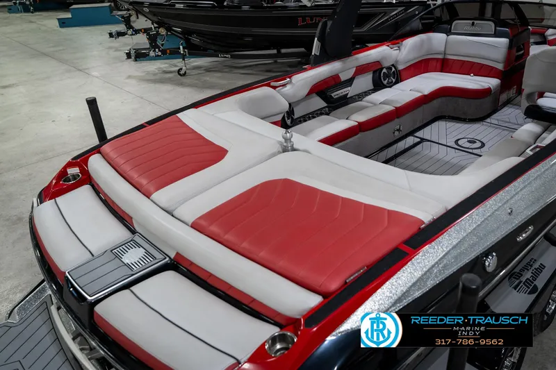 Slide: The Image of 2017 Malibu Wakesetter 25 LSV boat with red and white interior, displayed indoors. - 13
