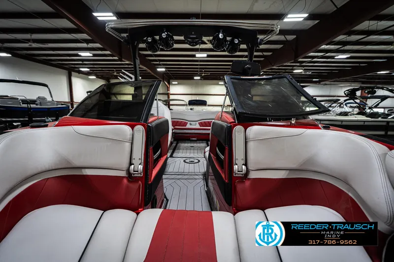 Slide: The Image of 2017 Malibu Wakesetter 25 LSV interior with red and white seating in showroom. - 18