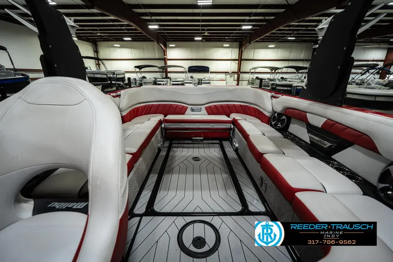 Slide: The Image of 2017 Malibu Wakesetter 25 LSV interior with red and white seating in a showroom. - 19